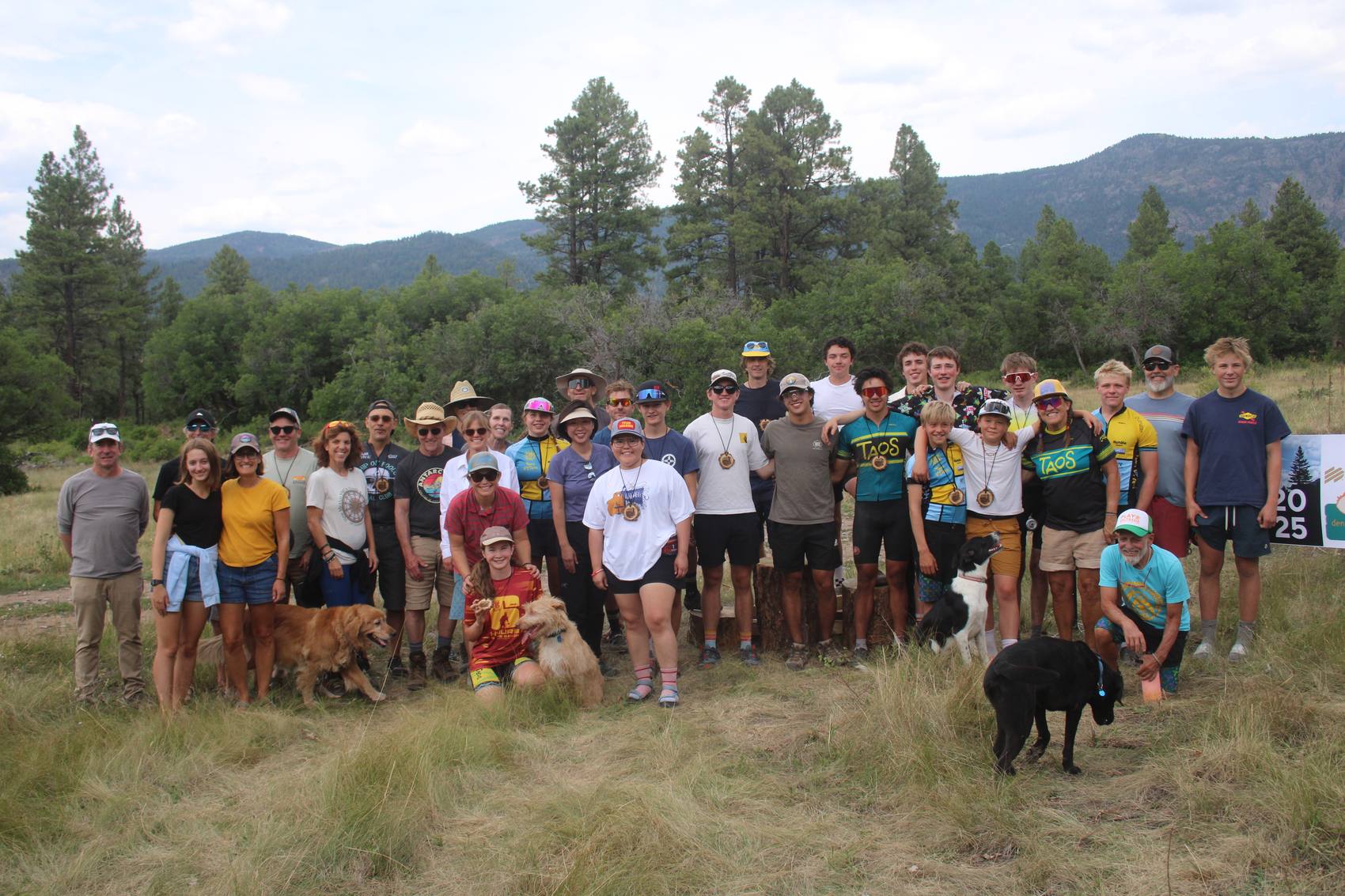Riders, volunteers, and dogs posing as a group after the race