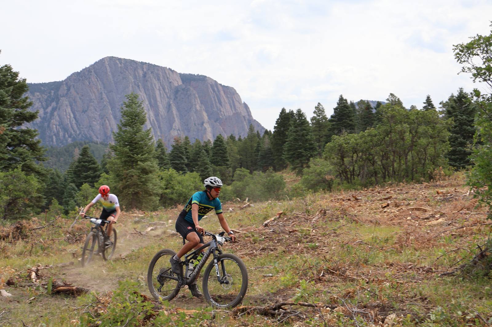 Group of riders crossing an open meadow